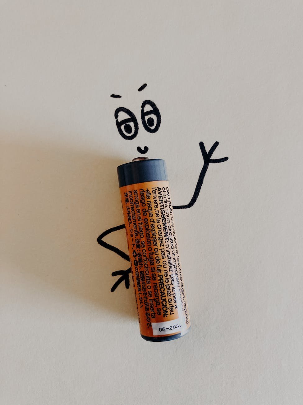 old orange battery on white surface