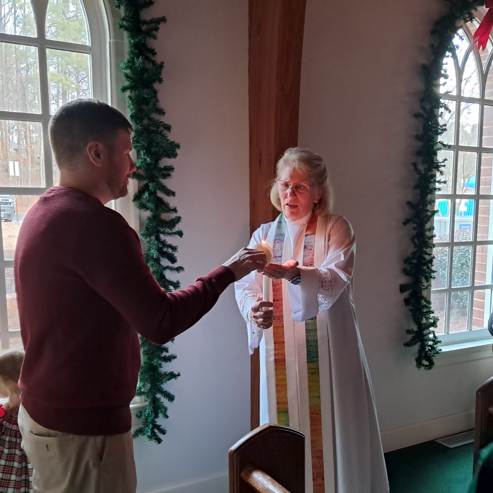 Candle light passing at Christmas Eve service.